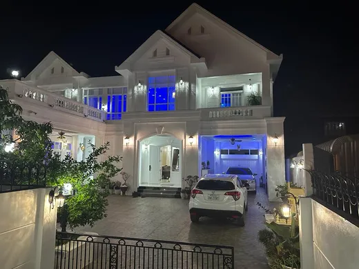 With wife Phousavath, elder son Nelas and younger son Gasos at his dream house