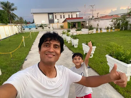 With his elder son, Nelas at his Farmhouse in Lao, PDR
