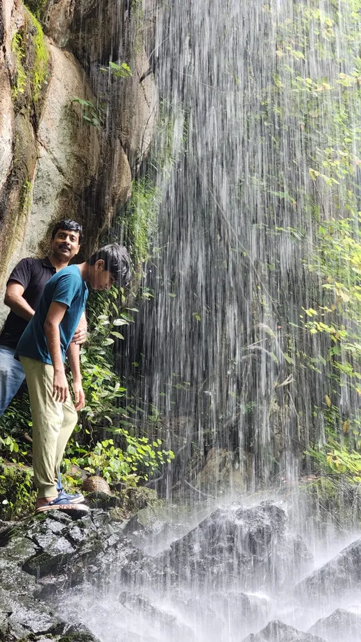 Enjoying a shower at a waterfall with my son
