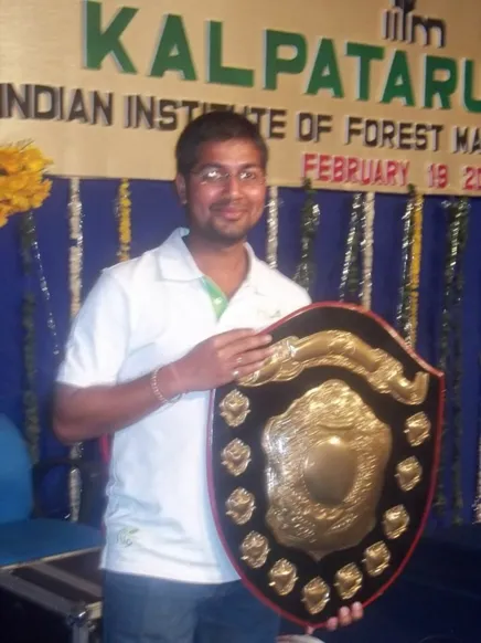 Deepak holding Best Club award given to Cultural Club during Kalpataru where he was an active member